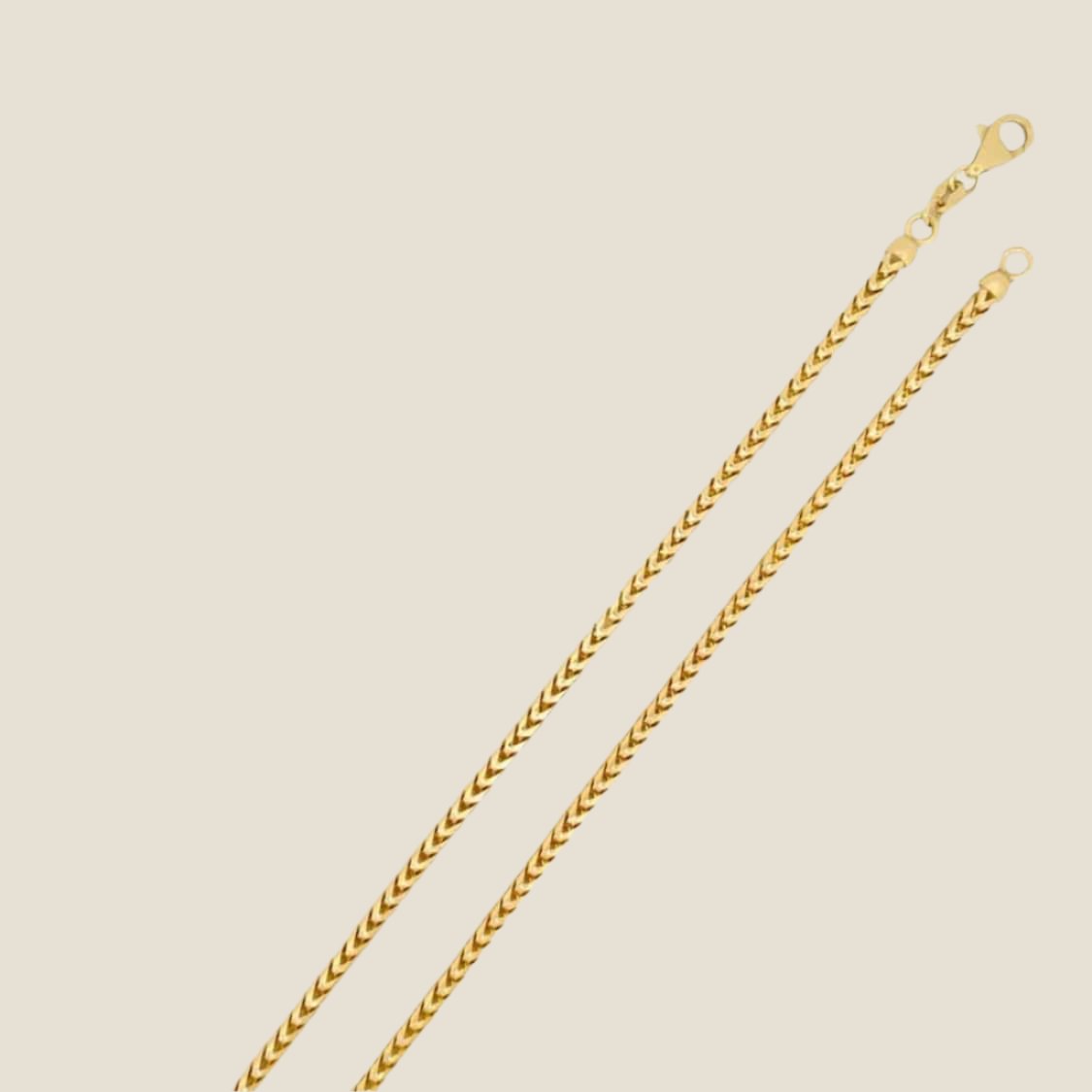 2.5MM Franco Chain in 14k solid gold with tightly interlocking links and a lobster clasp, designed for versatile wear.