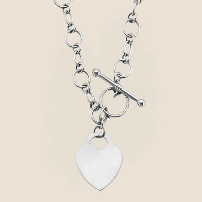 white gold necklace with heart pendant and a toggle clasp