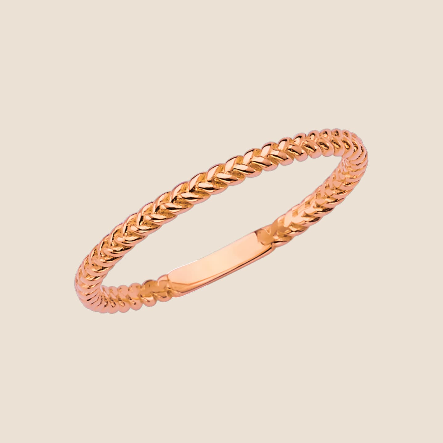 Delicate 14k yellow gold braided band ring with intricate texture, perfect for stacking and offering a sophisticated, stylish choice.