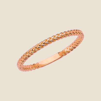 Delicate 14k yellow gold braided band ring with intricate texture, perfect for stacking and offering a sophisticated, stylish choice.