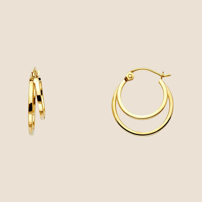 Double hoop earrings in 14k yellow gold, showcasing an elegant, dimensional design with distinct gold hoops. Made in USA, 17.5mm tall.