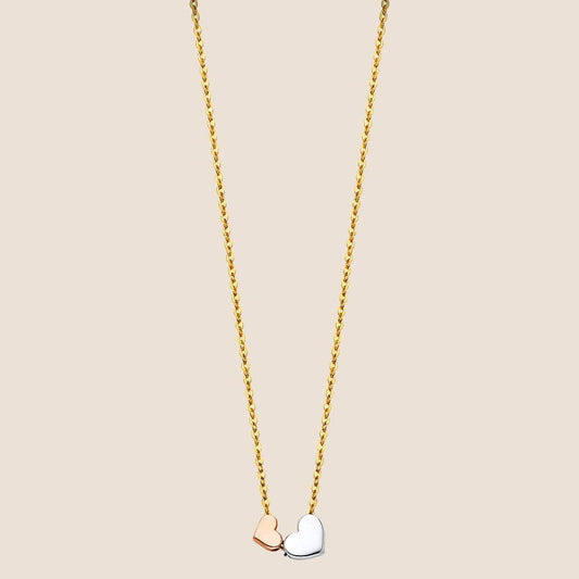 Two Hearts Necklace with intertwined rose gold and white gold heart pendants on a 14k gold chain. Adjustable length 17" + 1". Made in USA.