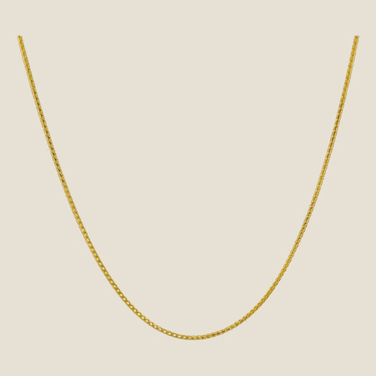 1MM Franco Chain in 14k solid gold with smooth, interlocking links and a lobster clasp, perfect for layering or solo wear, made in Italy