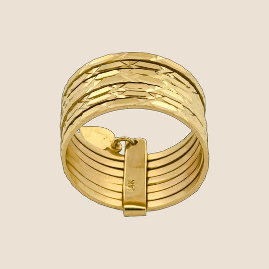 Seven layer yellow gold ring with elegant clasp, featuring intricately detailed and shimmering 14k gold bands, crafted in Italy.