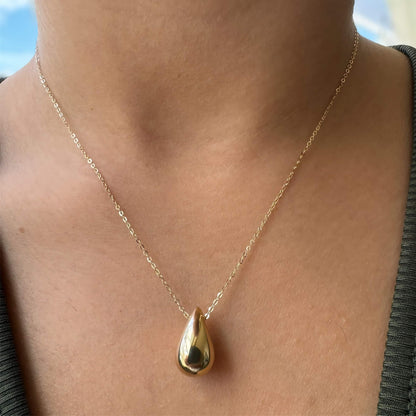 teardrop pendant suspended from a chain 